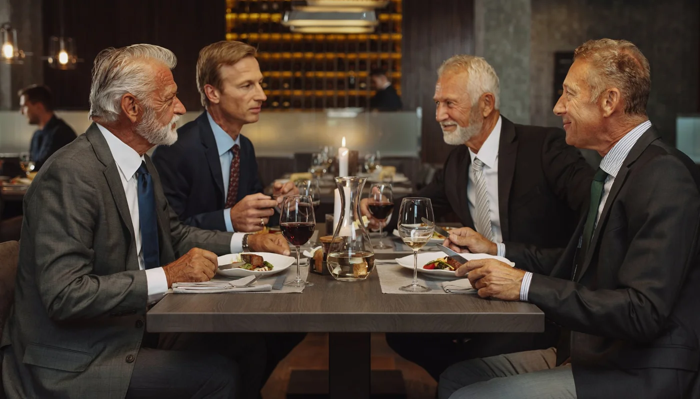 Senior business professionals at a dinner — building the relationships that open German doors